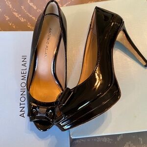 Heels, black patent with open toe.